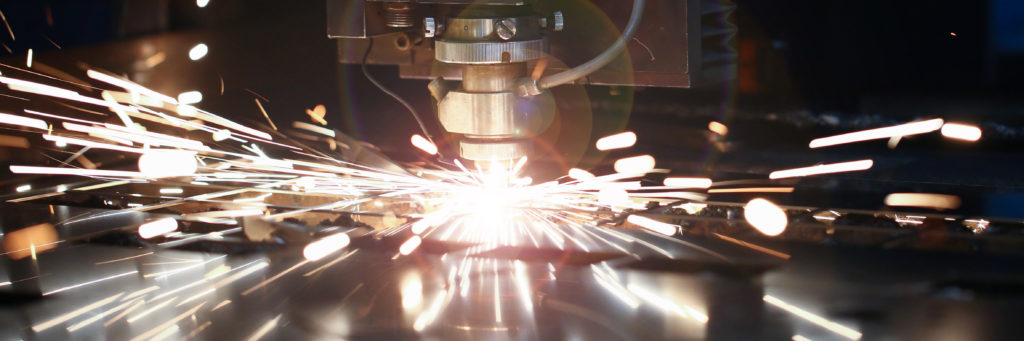 A CNC laser machine cutting through metal
